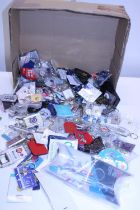 A large quantity of new keyrings and badges etc