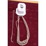 Two silver rings and a silver necklace and set of pearls with silver clasp