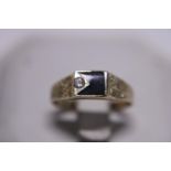 A 14ct gold Black Onyx and Diamond ring 2.14g. Size M1/2.