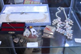 A shelf of vintage costume jewellery etc