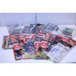 A job lot of assorted football programmes etc