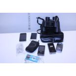A selection of assorted mobile phones and a pair of Minolta binoculars (untested)