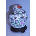 A hand decorated Chinese Ginger jar with six character mark to base on wooden stand