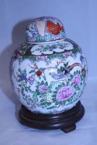 A hand decorated Chinese Ginger jar with six character mark to base on wooden stand