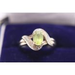 A vintage 9ct gold and green stone ring with diamonds to shoulders 2.26g. Size M.