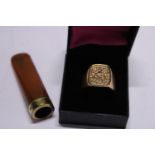 A men's gold plated signet ring and a gold plated and amber cigarette holder