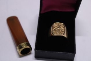 A men's gold plated signet ring and a gold plated and amber cigarette holder