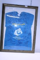 A framed T-shirt signed by the cast of Emmerdale, shipping unavailable