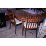 A vintage G plan extending round table with four chairs, shipping unavailable. 122cm in diameter