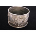 A Chinese silver Tuck Chang napkin ring with lotus flower decoration