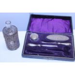 A selection of silver handled items and a glass bottle with hallmarked silver cover