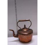 A large antique copper kettle