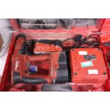 A Hilti hammer drill with charger and spare batteries (untested)