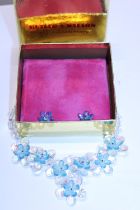 A boxed Butler and Wilson Blue flower necklace and earring set