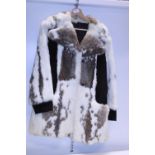 A vintage real fur coat with suede accents