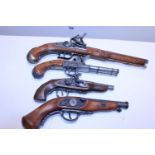 A selection of reproduction wall hanging pistols