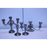 A pair of plated candlesticks and a two plated candelabra's