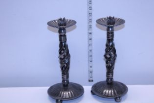 Two heavy base metal candlesticks