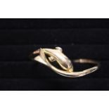 A solid 14ct gold bangle in the form of a dolphin. 12.30 grams.