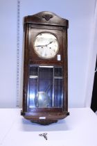 A Edwardian period wall clock with pendulum and key. Shipping unavailable