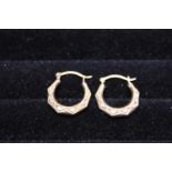 A pair of 9ct gold & patterned earrings 0.77 grams.