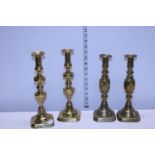 Two pairs of vintage brass candlesticks