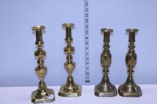 Two pairs of vintage brass candlesticks