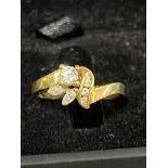 A quality 20ct gold ring set with one brilliant cut solitaire diamond four smaller brilliant cut