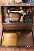 A antique manual singer sewing machine in case. Shipping unavailable