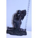 A heavy resin erotic sculpture