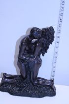 A heavy resin erotic sculpture