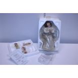 A boxed Heavens Little Angel Doll and three hanging ornaments