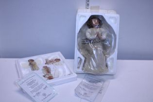 A boxed Heavens Little Angel Doll and three hanging ornaments