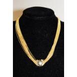 A quality 18ct gold multi stranded necklace with clasp. 39.35 grams