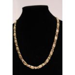 A heavy quality 14ct gold necklace in a criss cross design. 27.95 grams. 46cm long