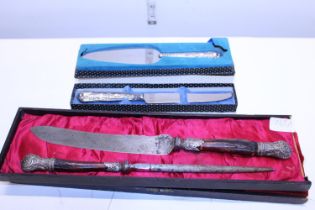 Two silver handles pieces of cutlery and a antique cased carving set with white metal mounts (