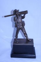 A statuette of a soldier on wooden base