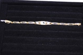 A quality 18ct gold bracelet set with diamonds. 14.31 grams