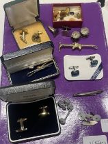 A selection of vintage cufflinks, tie pins etc