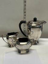 A fully hallmarked silver tea set with Bakelite handles gross weight 1064g (monogrammed)