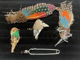 A selection of feather costume brooches