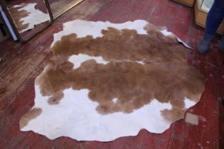 A cow hide rug 150x160cm approx.