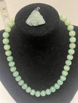 A vintage Jade? beaded necklace and Buddha pendant