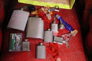 A box of assorted collectibles including hip flasks etc