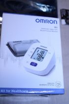 A boxed Omron blood pressure monitor (untested)