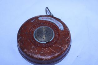 A leather Rathbone and sons tape measure