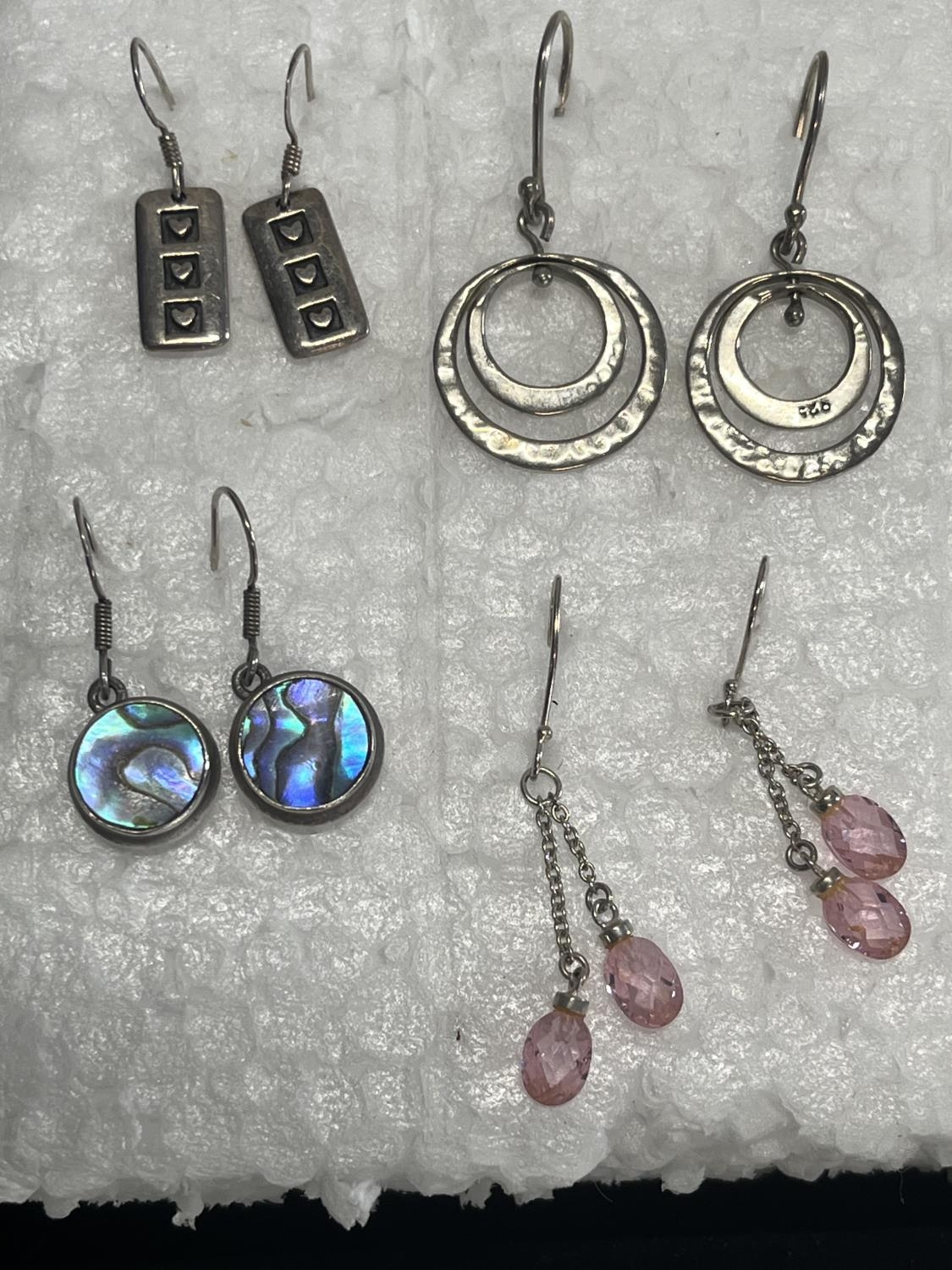 Four pairs of silver earrings