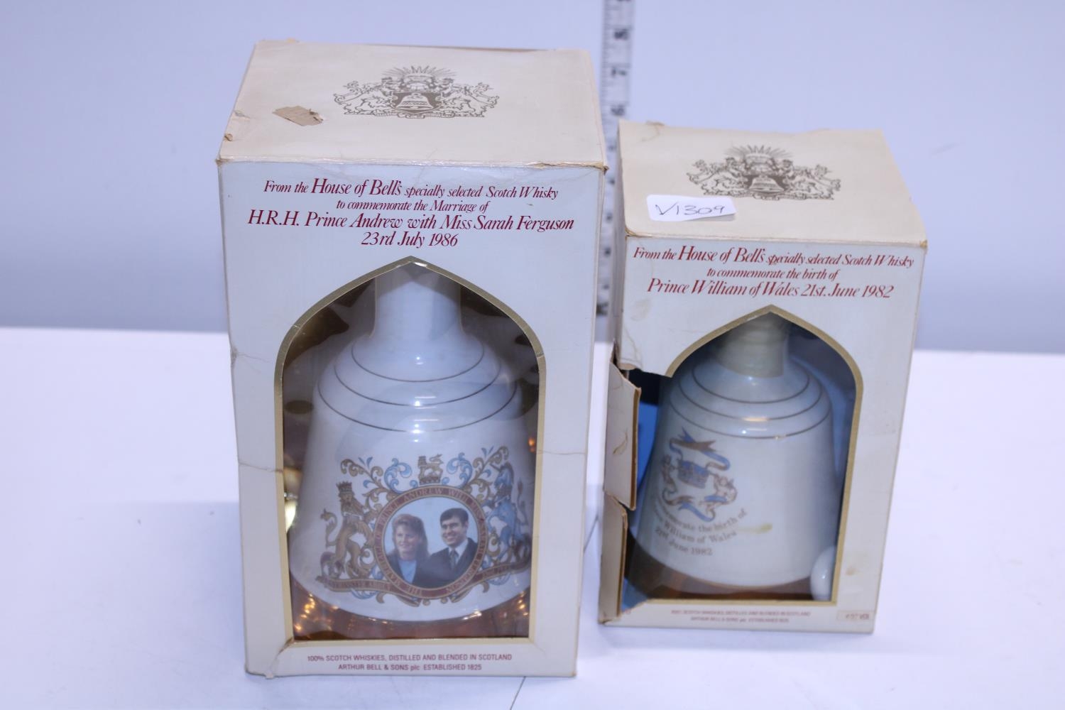 Two sealed bottles of Bell's commemorative whiskey