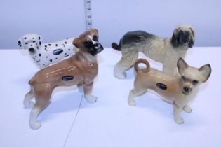 Four Cooper craft ceramic dog figures