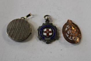 A silver locket a silver medal and a lodge medal